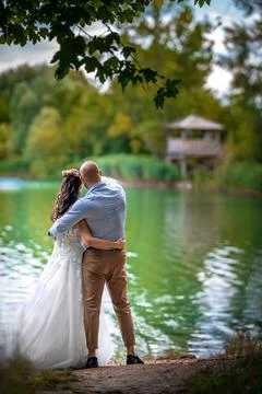 Amorous couple on the lake shore Stock Photos