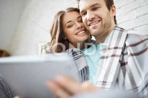 Amorous couple looking at touchpad at leisure Stock Photos