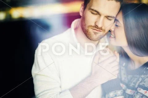 Amorous girl and guy with closed eyes enjoying time in cafe Stock Photos