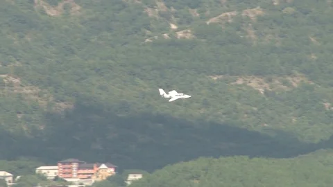 Amphibious aircraft Be-103 performs right turn over sea in Gelendzhin Bay. Stock Footage 120777557
