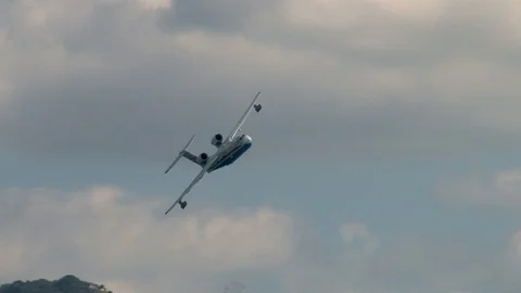 Amphibious aircraft Be-200ES performs aerobatics over waters of Bay. Video stock 125381901