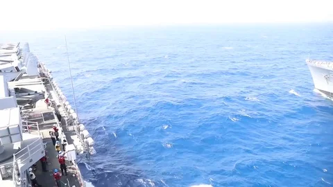 The amphibious assault ship USS Bataan (LHD 5) conducts a replenishment-at-sea Stock Footage 75834123