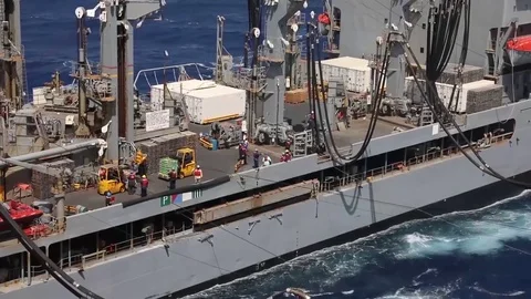 The amphibious assault ship USS Bataan (LHD 5) conducts a replenishment-at-sea Stock Footage 75834526