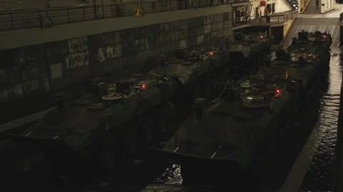 Amphibious Combat Vehicles lined up in well deck of transport dock ship Stock Footage 291101732