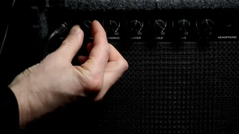 Amplifier close up musician plugging in microphone turning up volume. Singer of  Stock Footage 105746189