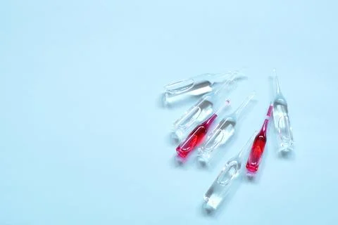 Ampoules on blue background Stock Photos