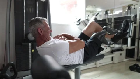 Amputee athlete doing sit-ups on the bench Stock Footage 276948047