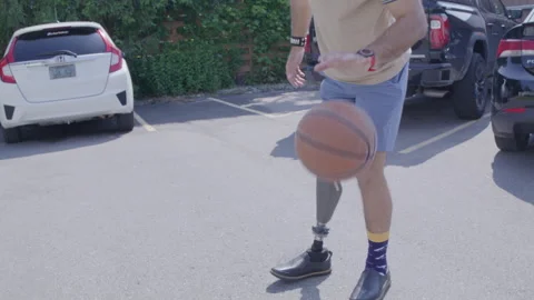 Amputee bouncing basketball slow motion Stock Footage 287492617
