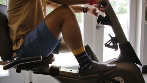Amputee doing physical therapy on a stationary bike Stock Footage 288234163