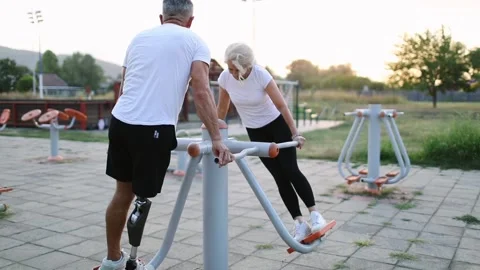 Amputee exercising together with supportive friend Stock Footage 292234765