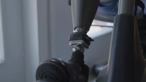 Amputee on stationary bicycle exercising Stock Footage 287504060