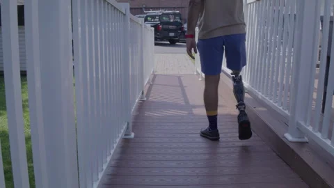 Amputee walking down a ramp Stock Footage 288521377