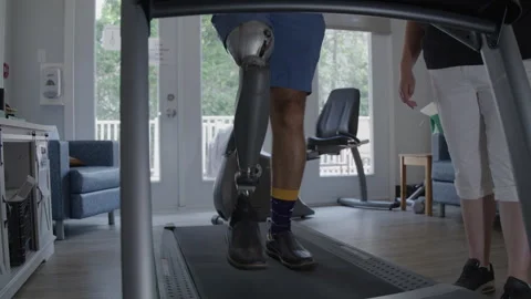 Amputee walking slow motion on treadmill Stock Footage 288234076