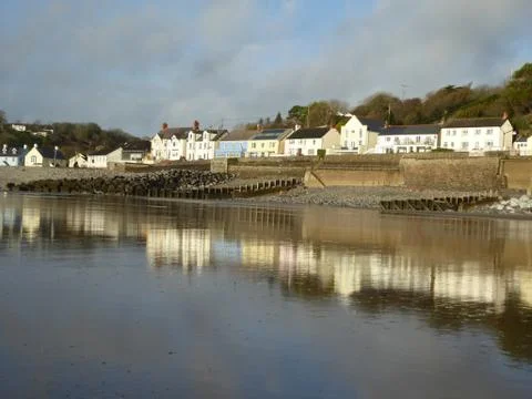 Amroth, Pembrokeshire - seafront houses reflected on watery beach Stock Photos