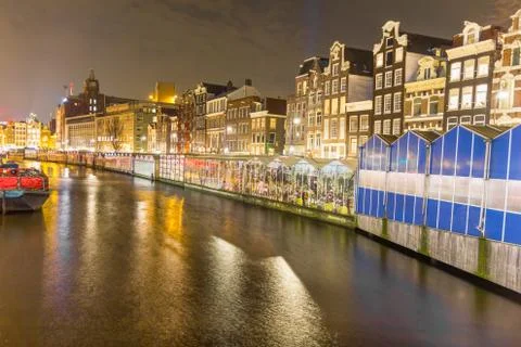 Amsterdam canal and the flower market at night Stock Photos