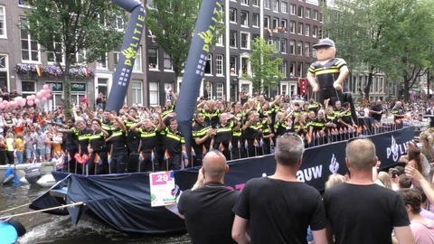 Amsterdam Canal Pride Float with partying policemen and women Stock Footage 128398148