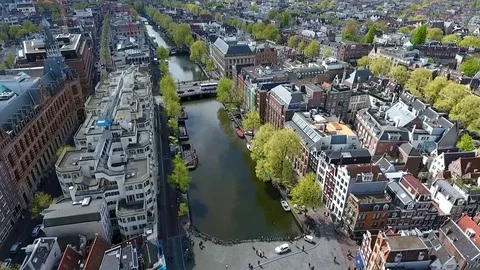 Amsterdam canal shot with a drone, rising up Stock Footage