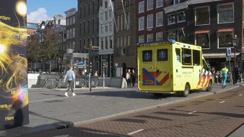 Amsterdam city center ambulance first aid responder emergency vehicle parked Stock Footage 220079110