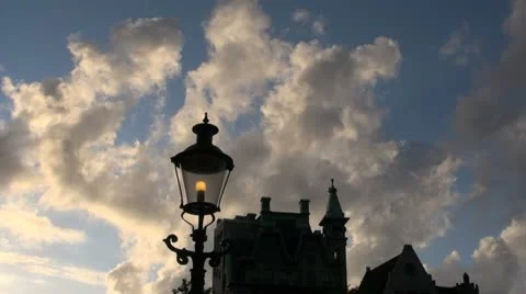 Amsterdam cloud above a building and street light timelapse Stock Footage 12050558