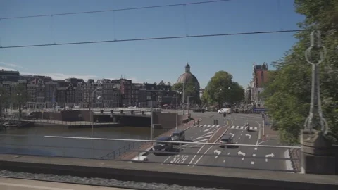 Amsterdam Main Train Station roll in view on canals Stock Footage 193690944