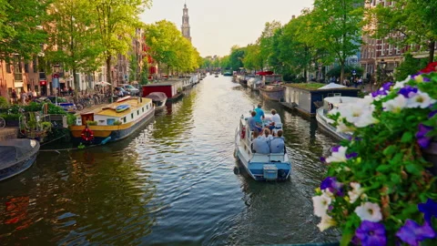 Amsterdam, Netherlands, August 20, 2025: Amsterdam canal, bicycles and bridges Stock Footage 317587120