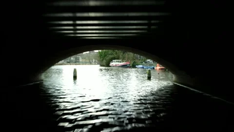 Amsterdam, Netherlands Flight Under The Bridge by Drone, Canal, River, Boat Stock Footage 234448435