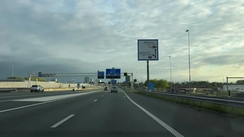 Amsterdam Ring Road A10 Driving Footage with Golden Hour Traffic and Green Lands Stock Footage 337069873