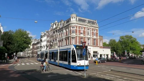 Amsterdam tram goes through an intersection with apartments in background. Stock-Footage 97808426