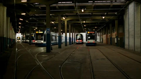 Amsterdam trams leaving an indoor public transport depot Stock-Footage 334785802