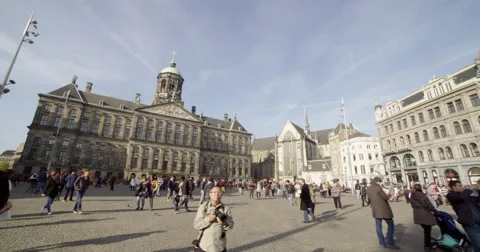 Amsterdam, wide angle panning shot of tourism Dam square with royal palace Stock Footage 56522231