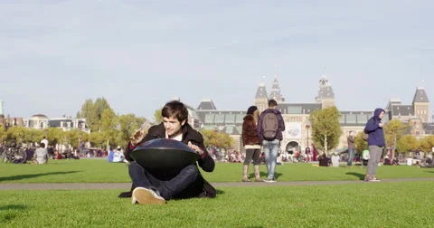 Amsterdam young man playing hang drum in park, 4K Stock Footage 56532577