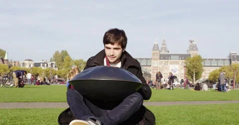 Amsterdam young man playing hang drum in park, 4K Stock Footage 56532685
