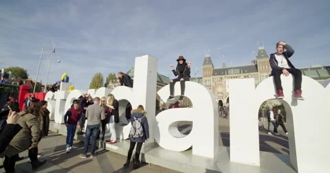 Amsterdam young tourists posing at landmark Stock Footage 56563832