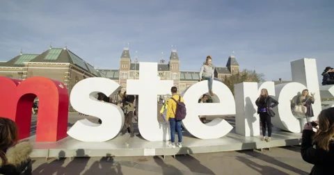 Amsterdam young tourists posing logo city Stock Footage 56563803