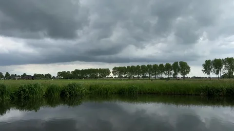 Amsterdan Forest, Low water-level pastoral pond reflecting heavy overcast sky Stock-Footage 342750924