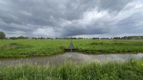 Amsterdan Forest, Narrow drainage ditch and sluice cut through green pasture 스톡 동영상 342752286