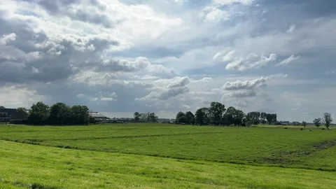 Amsterdan Forest, serene grass field under a cloudy sky viewed from above in Stock-Footage 342753103