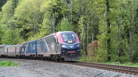 Amtrak Empire Builder passenger train on rural curve Stock Footage 276236090