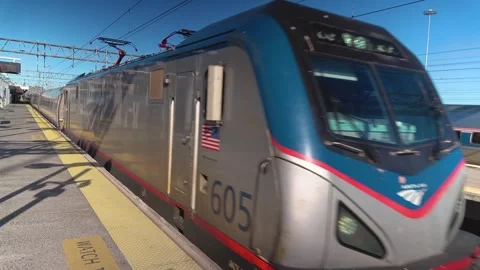 Amtrak Northeast Reginal train leaves station stock footage Stock Footage 303943974