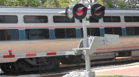 Amtrak Passes in Background of Blinking Red Warning Lights Stock Footage 37254248