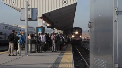 Amtrak train arriving during rush hour to LA Union Station platform Stock Footage 61065199
