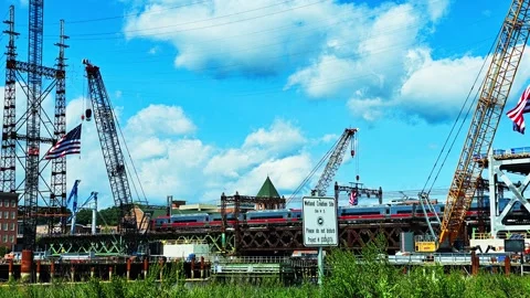 Amtrak train crossing bridge construction site in Norwalk, time lapse Stock Footage 344744997