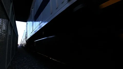 Amtrak Train passes by camera under bridge Video stock 76677564