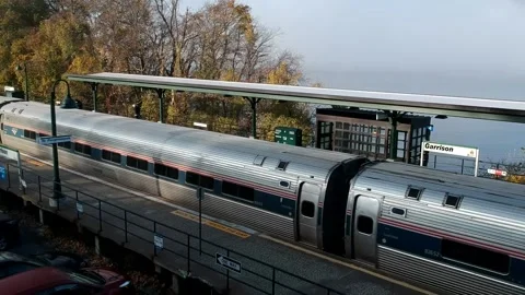 Amtrak train passes through Garrison Metro North Station (aerial) Stock Footage 142614862