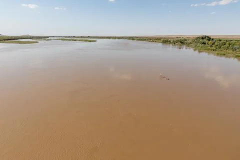 Amu Darya River flows peacefully near Kipchak village in Karakalpakstan Uzb.. Stock Photos
