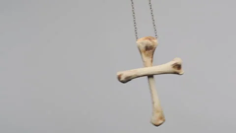 Amulet of bones sways in hypnosis close-up on white background Stock Footage 130346439