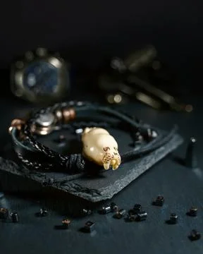 An amulet in the shape of a walrus head made of walrus tusk bone Stock Photos
