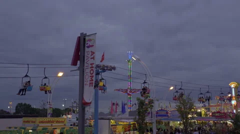 Amusement park and rides on a cloudy early evening. 4K UHD. 스톡 동영상 54263765
