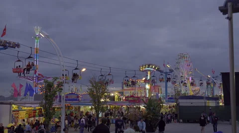 Amusement park and rides on a cloudy early evening. 4K UHD. Stock Footage 54265191