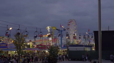 Amusement park and rides on a cloudy early evening. 4K UHD. 스톡 동영상 54266143